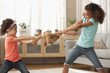 Mixed race sisters fighting over teddy bear