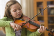 Caucasian girl playing violin