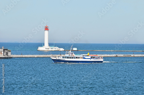 Photo: Motorboat near lighthouse and pier, Odessa, Ukraine Motorboat near lighthouse and pier, Odessa, Ukraine