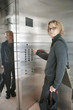 Caucasian man pressing elevator buttons