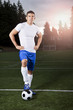 Hispanic athlete standing with soccer ball