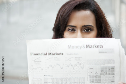 Photo: Indian woman reading newspaper Indian woman reading newspaper