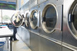 Hispanic woman doing laundry in self-service laundry facility