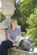 Hispanic woman looking at map in park