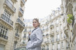 Hispanic woman standing on city street