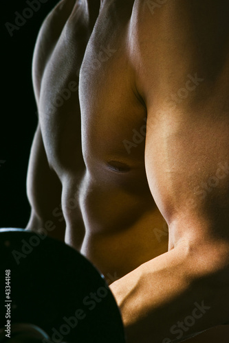 Photo: Caucasian man exercising with barbells Caucasian man exercising with barbells