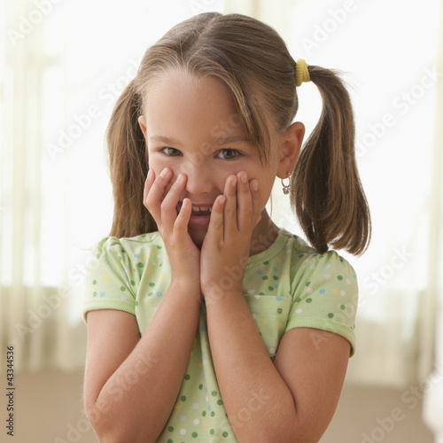 Photo: Smiling girl with hands covering face Smiling girl with hands covering face