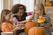 Girls carving pumpkins together