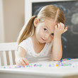 Caucasian girl stringing beads
