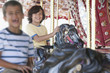 Excited brothers riding carousel