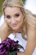 Hispanic bride holding bouquet of flowers