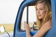 Caucasian woman driving old-fashioned truck