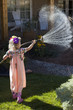 Caucasian girl watering garden