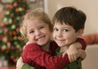 Girl and boy hugging on Christmas