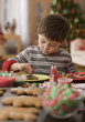 Caucasian boy making Christmas cookies