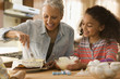 Grandmother and granddaughter baking a cake