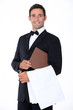 Well-dressed waiter holding menu