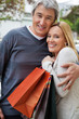 Foto: Cheerful Couple With Shopping Bags Cheerful Couple With Shopping Bags