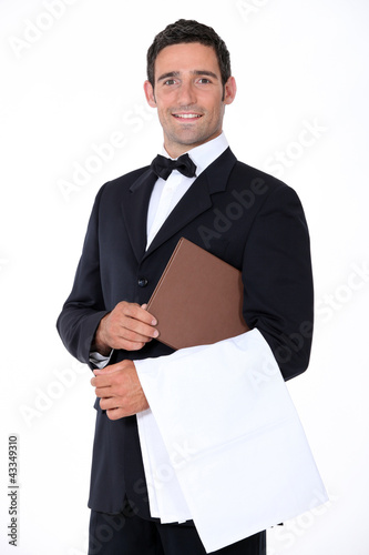 Photo: Well-dressed waiter holding menu Well-dressed waiter holding menu