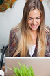 Woman Using Laptop in Cafe