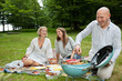 Photo: Friends Having Meal At An Outdoor Picnic Friends Having Meal At An Outdoor Picnic