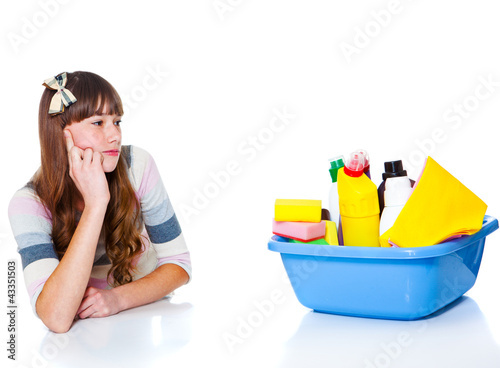 Photo: Girl looking at chemical detergents Girl looking at chemical detergents