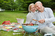 Couple Cooking Meat On Barbecue