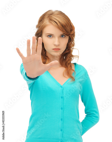 Photo: young woman making stop gesture young woman making stop gesture
