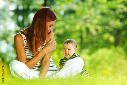 Photo: Mother and daughter on the green grass Mother and daughter on the green grass