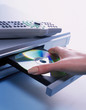 woman putting DVD into DVD player