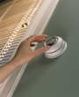 Woman changing temperature on thermostat
