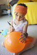 Mixed race girl drawing on balloon