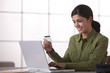 Hispanic woman shopping online with credit card