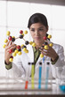 Hispanic scientist looking at molecule model