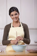 Hispanic woman baking in kitchen