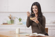 Hispanic woman eating cereal for breakfast