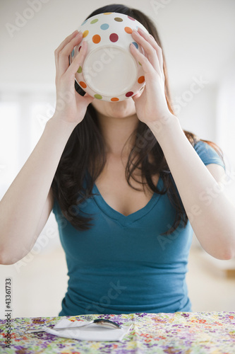 Photo: Korean woman drinking from bowl Korean woman drinking from bowl