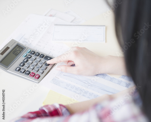 Photo: Korean woman using calculator Korean woman using calculator