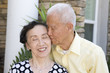Senior Chinese man kissing wife