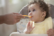 Father feeding baby girl