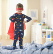 Caucasian boy playing in superhero costume