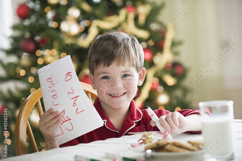 Photo: Caucasian boy writing Christmas letter to Santa Caucasian boy writing Christmas letter to Santa