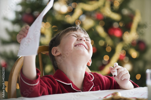 Photo: Caucasian boy writing Christmas letter to Santa Caucasian boy writing Christmas letter to Santa