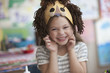 Caucasian girl making lion mask