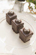 Three chocolate ganache petite cakes