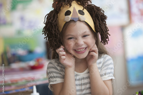 Photo: Caucasian girl making lion mask Caucasian girl making lion mask