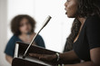 Mixed race teenage girl giving speech to classmates