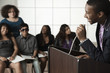 Teenage boy giving speech to classmates