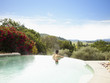 Man at a luxury resort in infinity pool overlooking Napa Valley, California