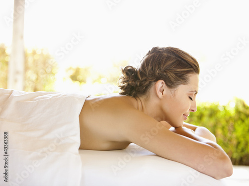 Photo: Smiling woman with eyes closed lying on massage table at luxury spa in Napa Valley California Smiling woman with eyes closed lying on massage table at luxury spa in Napa Valley California